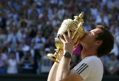 Andy Murray of Britain kisses the winners trophy after defeating Novak Djokovic of Serbia in their men's singles final tennis match at the Wimbledon Tennis Championships, in London July 7, 2013. REUTERS