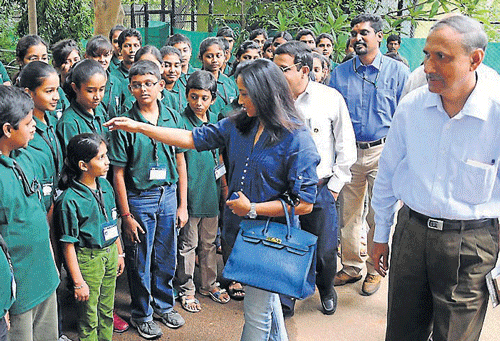 young greens: Former athlete Ashwini Nachappa interacts with students during the opening of Zoo Youth Club in Mysore on Sunday. Director of Project Elephant Ajai Misra and Executive Director of Zoo B&#8200;P&#8200;Ravi are seen.  dh photo