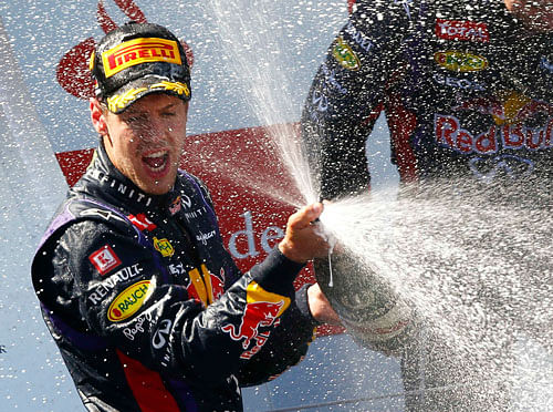 Red Bull Formula One driver Vettel of Germany sprays champagne on the podium after winning the German F1 Grand Prix at the Nuerburgring racing circuit reuters