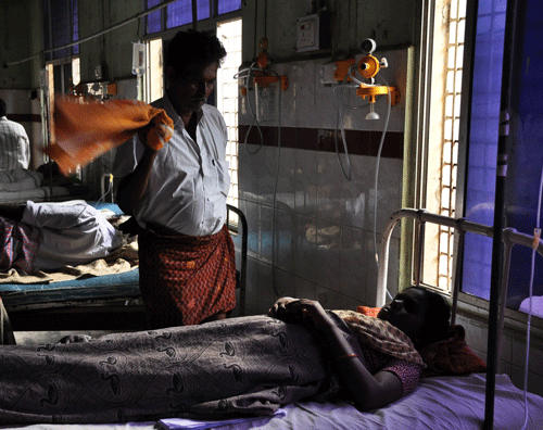 A man fans a patient using a hand towel during a power outage at a government hospital in Kurnool, Andhra Pradesh state, India, Wednesday, Oct.9, 2013. Millions of people in southeastern India were facing widespread power blackouts for the sixth consecutive day Wednesday after talks between the government and striking electricity workers failed.Workers have shut down power plants across Andhra Pradesh state to protest a decision to divide the state into two, creating the new state of Telangana. (AP Photo