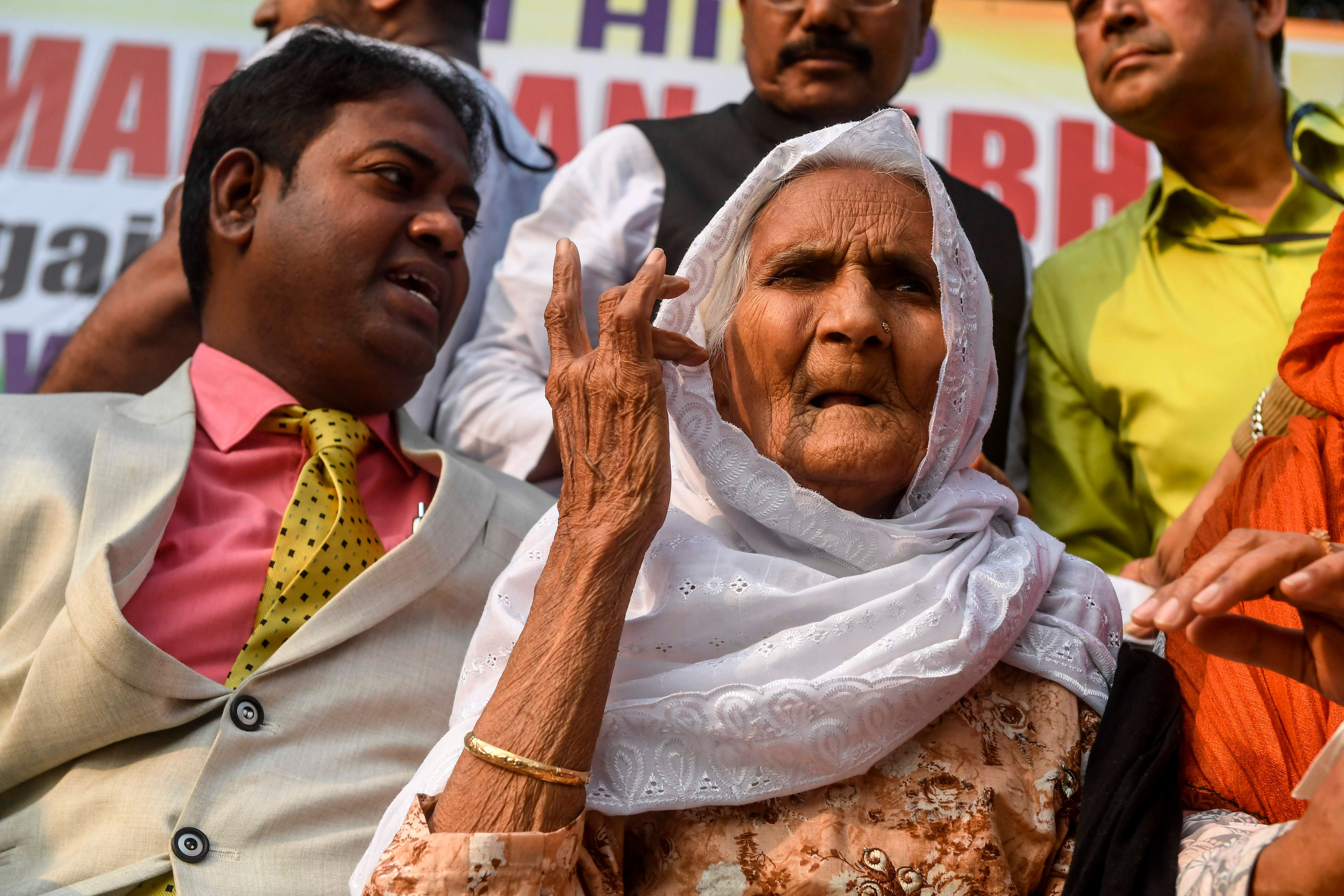 Shaheen Bagh's 'Dadi' (grandmother) Asma Khatoon (R), 90, and great grandson of B.R. Ambedkar, Rajratna Ambedkar (L), gesture as they protest against India's new citizenship law during a demonstration in Kolkata. (AFP Photo)