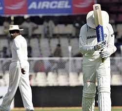 Indian cricketer Harbhajan Singh, right, reacts after being dismissed, as Sri Lanka's Mahela Jayawardene looks on during the second day of the first Test cricket match between India and Sri Lanka in Ahmadabad on Tuesday. AP
