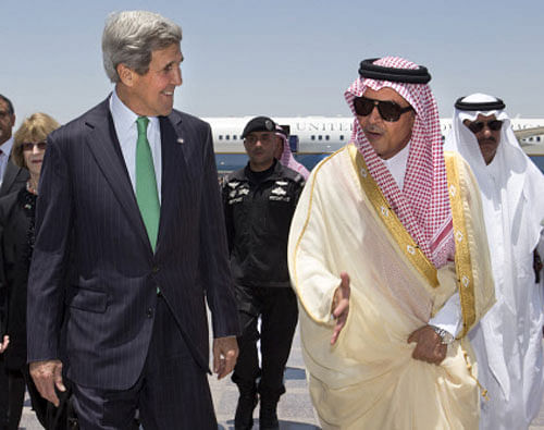 FILE - In this Tuesday, June 25, 2013 file photo, U.S. Secretary of State John Kerry, left, is greeted by Saudi Foreign Minister Prince Saud al-Faisal upon arrival in Jeddah, Saudi Arabia. One day, Saudi Arabia looks to spend $6.8 billion in its latest buying spree of American weapons. Two days later, the kingdom vents its anger at the U.S. 's Mideast policy by snubbing a seat on the U.N. Security Council in a show of discontent. A mix of both customer and critic, Saudi Arabia is trying to carve out its own path to counter U.S. moves such as outreach to Iran, while knowing it still needs its longtime ally as a powerful big brother. AP