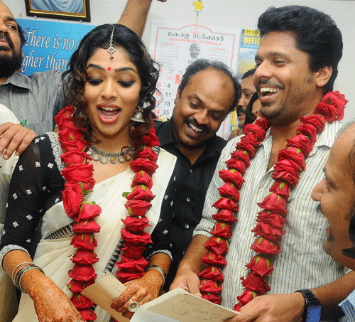 Malayalam film actress Rima Kallingal with Director Aashiq Abu after their marriage at the Sub-Registrar's office at Kochi on Friday. PTI Photo