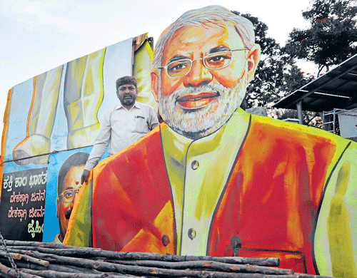 swansong: Artist Gopalakrishna shifts a 46-foot cutout of BJP leader Narendra Modi, the last of the Rajkamal Art works, to the Palace Grounds on Friday. dh photo