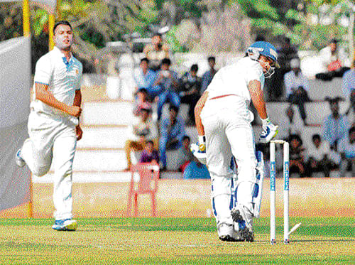 Got him! Karnataka's Stuart Binny sends Punjab batsman Sandeep Sharma's stump                         cartwheeling during their Ranji Trophy match in Hubli on Saturday. DH photo/ MR manjunath