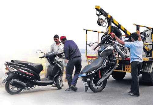 careless: Two-wheelers  being lifted into the  towing vehicles without proper support.