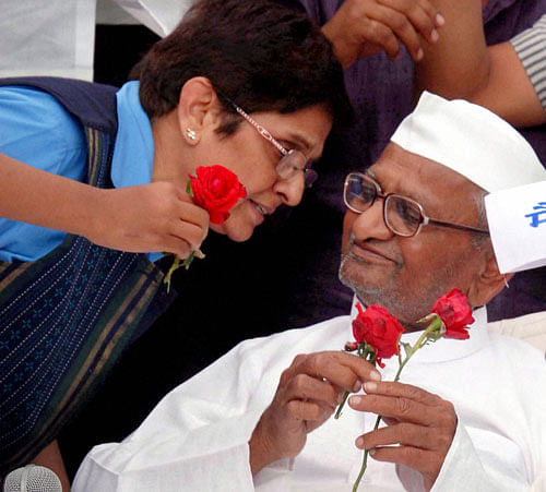 Anna Hazare with Kiran Bedi receives roses in Ralegan Sidhi, Ahmednagar as they celebrate after the passage of Lokpal Bill by the Lok Sabha on Wednesday. PTI Photo
