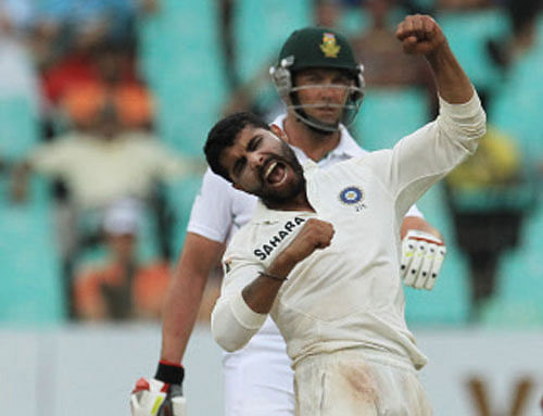 Ravindra Jadeja, front, celebrates taking the wicket as South Africa's batsman Jacques Kallis, watches on the third day of their cricket test match against South Africa at Kingsmead stadium, Durban, South Africa, Saturday, Dec. 28, 2013. (AP Pho)