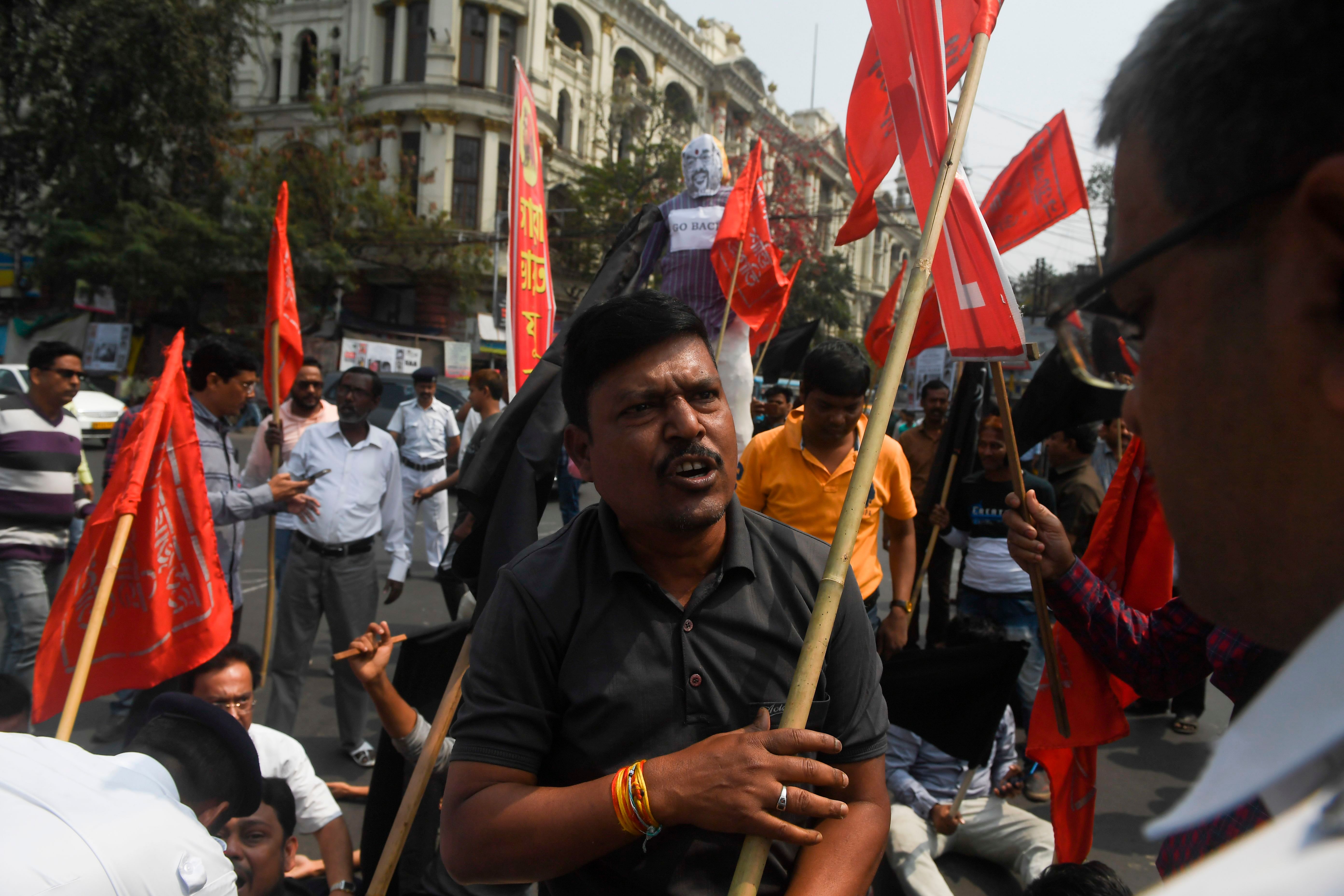 All India Youth League activists are stopped by police during a protest against India's new citizenship law and Indian Minister of Home Affairs Amith Shah presence for a political rally in Kolkata. (Credit: AFP Photo)