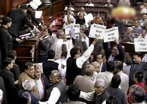 Amid noisy scenes, the Rajya Sabha Thursday debated the bill to grant separate statehood to Telangana region of Andhra Pradesh.  PTI Photo