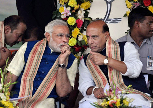 BJP's PM candidate Narendra Modi with party President Rajnath Singh at a public rally in Bhubaneswar on Tuesday. PTI Photo