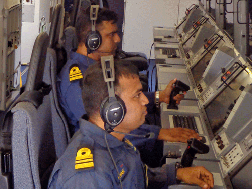 Indian navy officers work inside the control room of the Indian aircraft "P8i, a long-range maritime patrol," as it patrols over the Bay of Bengal and Andaman Sea, India, Saturday, March 15, 2014. Indian navy ships supported by long-range surveillance planes and helicopters scoured Andaman Sea islands for a third day on Saturday without any success in finding evidence of the missing Malaysia Airlines jet, officials said. (AP Photo)