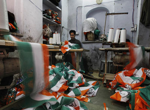 A worker stitches flags, banners and other election related merchandise at a workshop in New Delhi, AP photo