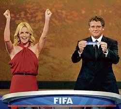 South African actress Charlize Theron  cheers as FIFA General Secretary Jerome Valcke holds up South Africas name during the World Cup draw on Friday. Reuters