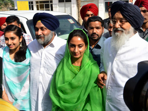 Punjab Chief Minister Parkash Singh Badal, Deputy CM Sukhbir Singh Badal, his wife & SAD candidate from Bathinda seat Harsimrat Kaur Badal after casting votes for Lok Sabha elections in Bathinda on Wednesday. is also seen. PTI Photo