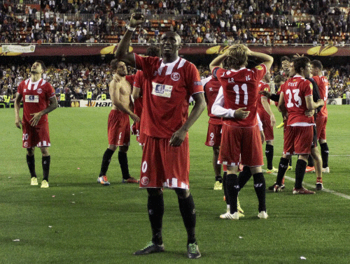 Sevilla's Stephane Mbia greets supporters next to team mates as they celebrate their victory over Valencia after their Europa League semi-final second leg soccer match at the Mestalla stadium in Valencia, May 1, 2014. Reuters photo