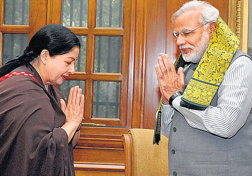 Prime Minister Narendra Modi exchanges greetings with Tamil Nadu Chief Minister J Jayalalitha at a meeting in New Delhi on Tuesday. PTI