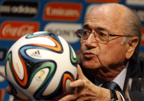 FIFA President Sepp Blatter holds an official 2014 FIFA World Cup soccer ball during a media conference in Sao Paulo. Reuters Photo