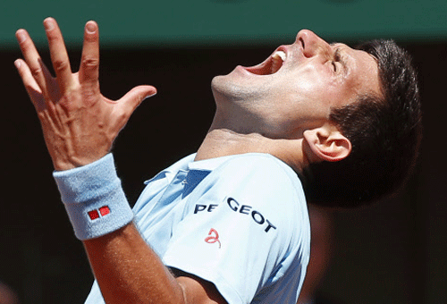Novak Djokovic of Serbia celebrates after winning his men's semi-final match against Ernests Gulbis of Latvia at the French Open tennis tournament at the Roland Garros stadium in Paris. AP photo