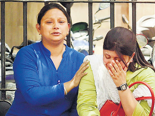 Family members of one of the convicts at Tis Hazari Court in New Delhi on Monday. PTI