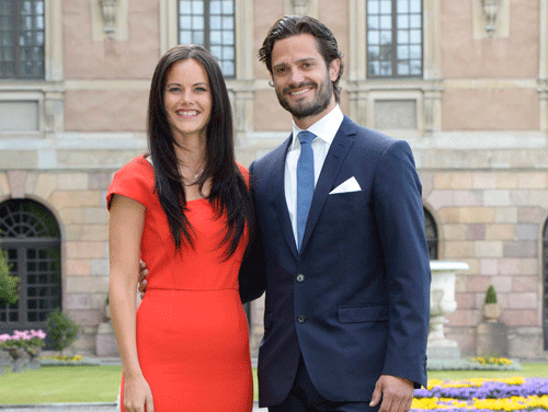 Sweden's Prince Carl Philip (R) and Sofia Hellqvist pose at a news conference where they announced their engagement at Stockholm Palace, June 27, 2014. Prince Carl Philip, third in line to the throne of Sweden, will marry his longtime girlfriend, 29-year-old former model Hellqvist, the royal court said on Friday. 'The wedding date has not yet been decided but it is planned to take place during the summer of 2015,' it announced in a statement. REUTERS