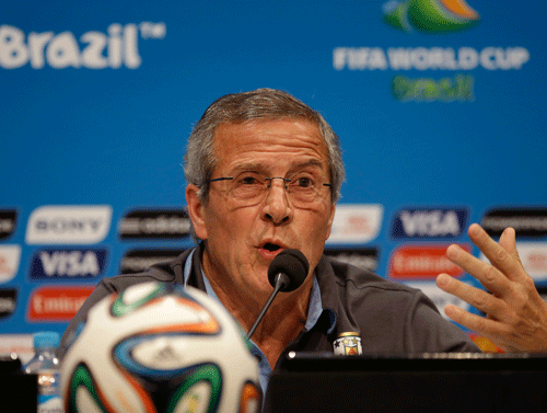 Uruguay's head coach Oscar Tabarez makes a statement during a press conference the day before the round of 16 World Cup soccer match between Colombia and Uruguay at the Maracana Stadium in Rio de Janeiro, Brazil, Friday, June 27, 2014. FIFA banned Uruguay striker Luis Suarez from all football activities for four months on Thursday for biting an opponent at the World Cup, a punishment that rules him out of the rest of the tournament and the start of the upcoming Premier League season.  AP