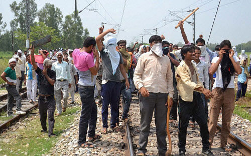 BJP Mahapanchayat supporters during a clash at Kanth Railway Station in Moradabad district on Friday. PTI Photo