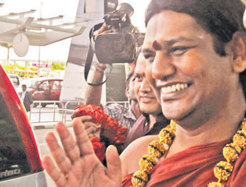 Nithyananda arrives at  Kempegowda International  Airport in Bangalore on  Tuesday. DH Photo