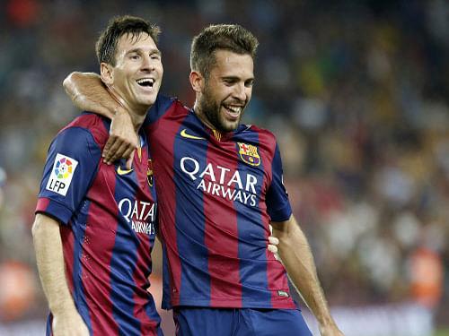 Messi celebrates with team-mate Jordi Alba after scoring during their Spanish league game against Elche on Sunday. Reuters