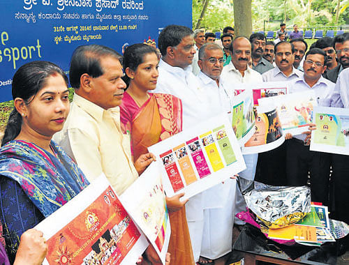 District-in-Charge Minister V Sreenivas Prasad launches the Mysore Tourist Passport, in Mysore, on Sunday. Deputy Commissioner C Shikha, MLA G T Devegowda and others are seen. DH PHOTO