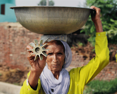 A village woman shows the tail of a mortar shell fired from the Pakistan side at Arnia sector in Jammu on Tuesday. PTI Photo(