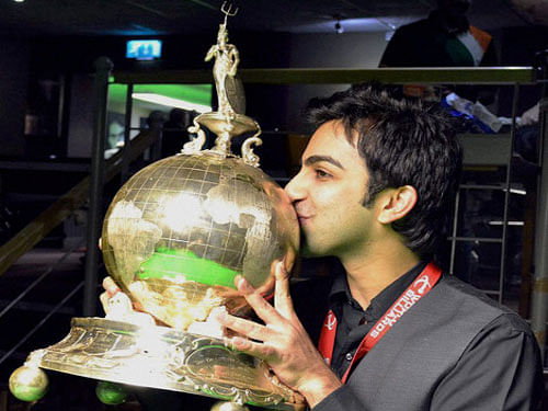 Pankaj Advani poses with the trophy after winning the World Billiards Championship (time format) in Leeds. Pankaj Advani might have become the toast of India after winning the World Billiards title (time format), but the ace cueist's mother Kajal says it is elder brother and sports psychologist Shree's 'gyaan' that often does the trick for him. PTI photo