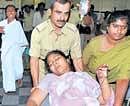 IN PAIN: Slain forest brigand Veerappans wife Muthulakshmi being wheeled into K R Hospital in Mysore on Thursday. DH Photo