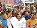 Nurse Jayalakshmi staging a protest against Minister Renukacharya in the City on Thursday.