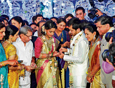 Minister Shamanur Shivashankarappa's granddaughter Anchal and Jagadish Shettar's son Prashanth exchange rings during their betrothal ceremony in Davangere on Monday evening. Shivashankarappa, Shilpa Shettar, Jagadish Shettar and others are present. DH photo