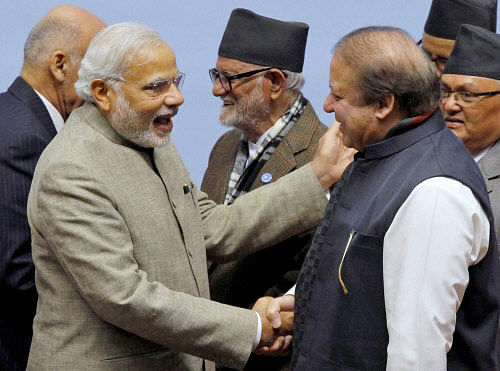 Prime Minister Narendra Modi shakes hands with his Pakistani counterpart Nawaz Sharif at the 18th SAARC Summit in Kathmandu, Nepal on Thursday. Nepal PM Sushil Koirala is also seen. PTI Photo