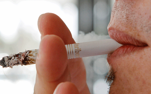 Smoking can inhibit the success of treatment for alcohol abuse, says a study, adding that it puts people who are addicted to both tobacco and alcohol in a double bind. AP File Photo.