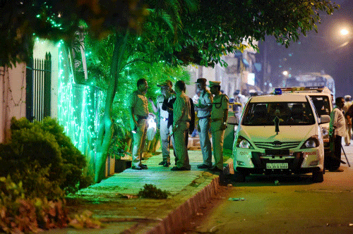 Police officials on spot where a low intensity bomb blast occurred at church street in Bengaluru on Sunday night. PTI Photo