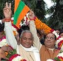 Former Uttar Pradesh chief minister Kalyan Singh (L) being garlanded by supporters at his residence in Lucknow after he announced formation of his new Jan Kranti Party on his birthday on Tuesday. Kalyan's son and party's national president Rajveer waves the party flag. PTI