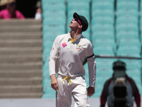 Steve Smith looks up in the direction of the Spidercam suspended above the playing field after he dropped a catch on the third day of their cricket test match against India in Sydney. AP Photo