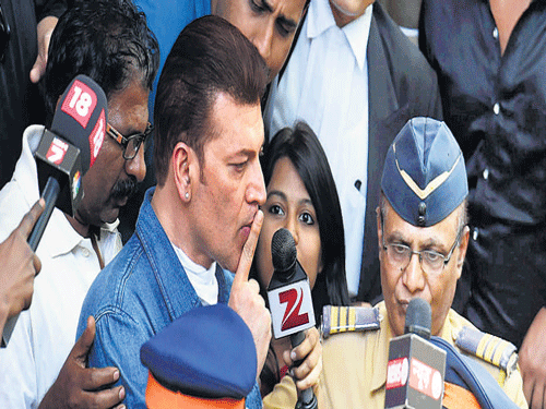 Actor Aditya Pancholi gestures to mediapersons after coming out from a court in Mumbai on Sunday. PTI