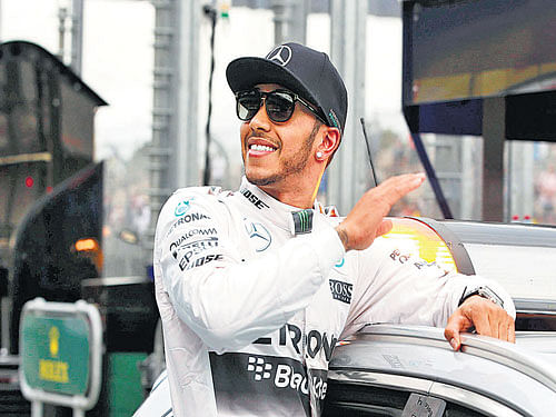 smooth start: Mercedes' Lewis Hamilton celebrates after securing the pole position in the Australian GP. reuters