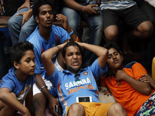 Even as India's loss to Australia by 95 runs in the Semi-final of the ongoing World Cup left Indian cricket fans with a broken heart, Times Now's  #ShamedinSydney hashtag did not go down well with everyone. Indian cricket fans react as they watch on television the ICC Cricket World Cup semifinal match between India and Australia. AP photo