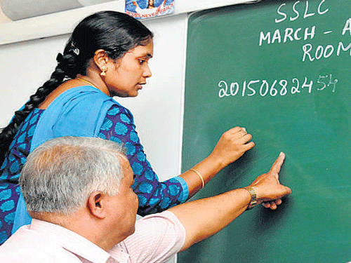 Teachers mark register numbers at St Mary's Girls High School in the City, on the eve of SSLC examination. DH PHOTO