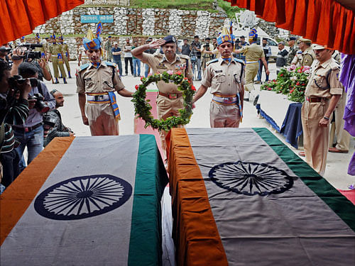 Director General of Jammu and Kashmir police K Rajendra Kumar salutes at the coffin of two CRPF personnel during a wreath laying ceremony at Humahama in Srinagar on Tuesday. Two CRPF personnel were killed in a attack by militants at Halmulla Sangam in Anantnag District of South Kashmir Yesterday. PTI Photo