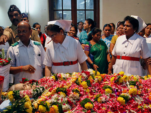 Hospital nurses gather around the body of Aruna Shanbaug, as they pray for her, during her funeral, in Mumbai, India, Monday, May 18, 2015. Shanbaug, a Mumbai nurse who was in a vegetative state for 42 years after being sexually assaulted while working in a hospital has died, authorities said Monday. Aruna Shanbaug, 67, suffered severe brain damage when she was sodomized and strangled with a metal chain by a hospital worker in 1973. AP Photo