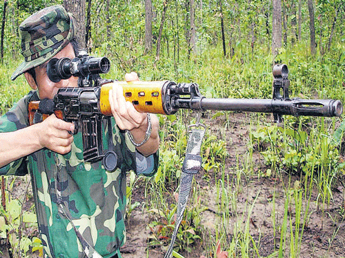 A cadre of the Manipur-based People's Liberation Army with sophisticated weapon at the outfit's hideout. PTI FILE PHOTO