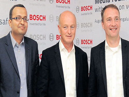 Kartikeya Joshi, Hans-Peter Hubner and Robert Bosch Chassis Systems Control EVP (Active Safety Business) Klaus Maeder in Bengaluru on Thursday. DH photo