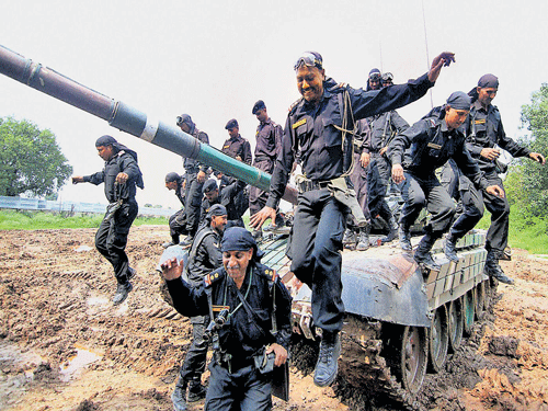 Army personnel raise slogans near the T72 Tank during an event to mark the victory of 1965 Indo-Pak war in Jammu on Monday. PTI